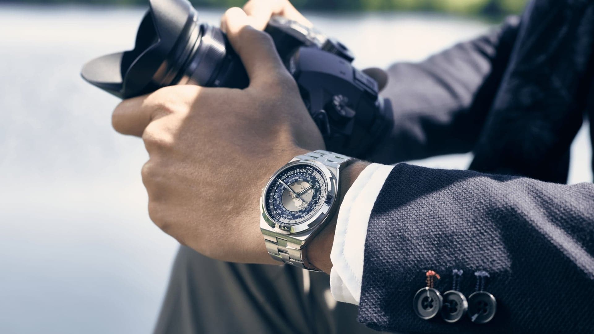 Man in a suit wearing Vacheron Constantin Overseas World Time.