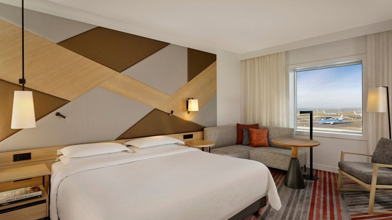 Hotel room at Sheraton Amsterdam with white beds and creamy colours