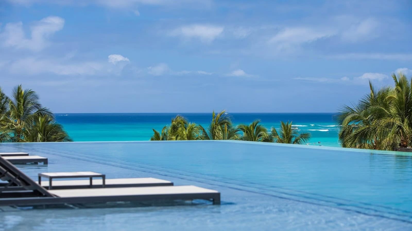 Infinity pool with floating sunbeds at Alohilani Resort, Waikiki Beach.