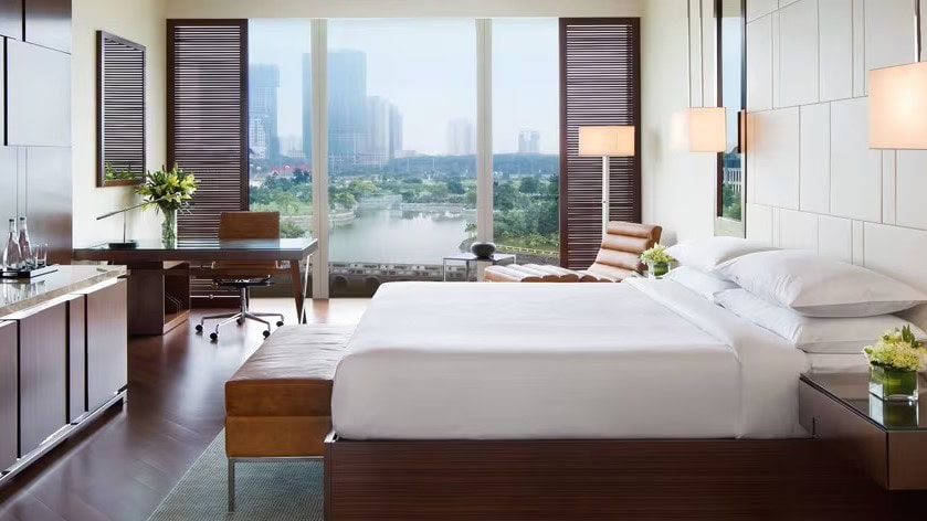 a room at JW Marriott Hotel Hanoi with a view of the city and lake through its windows