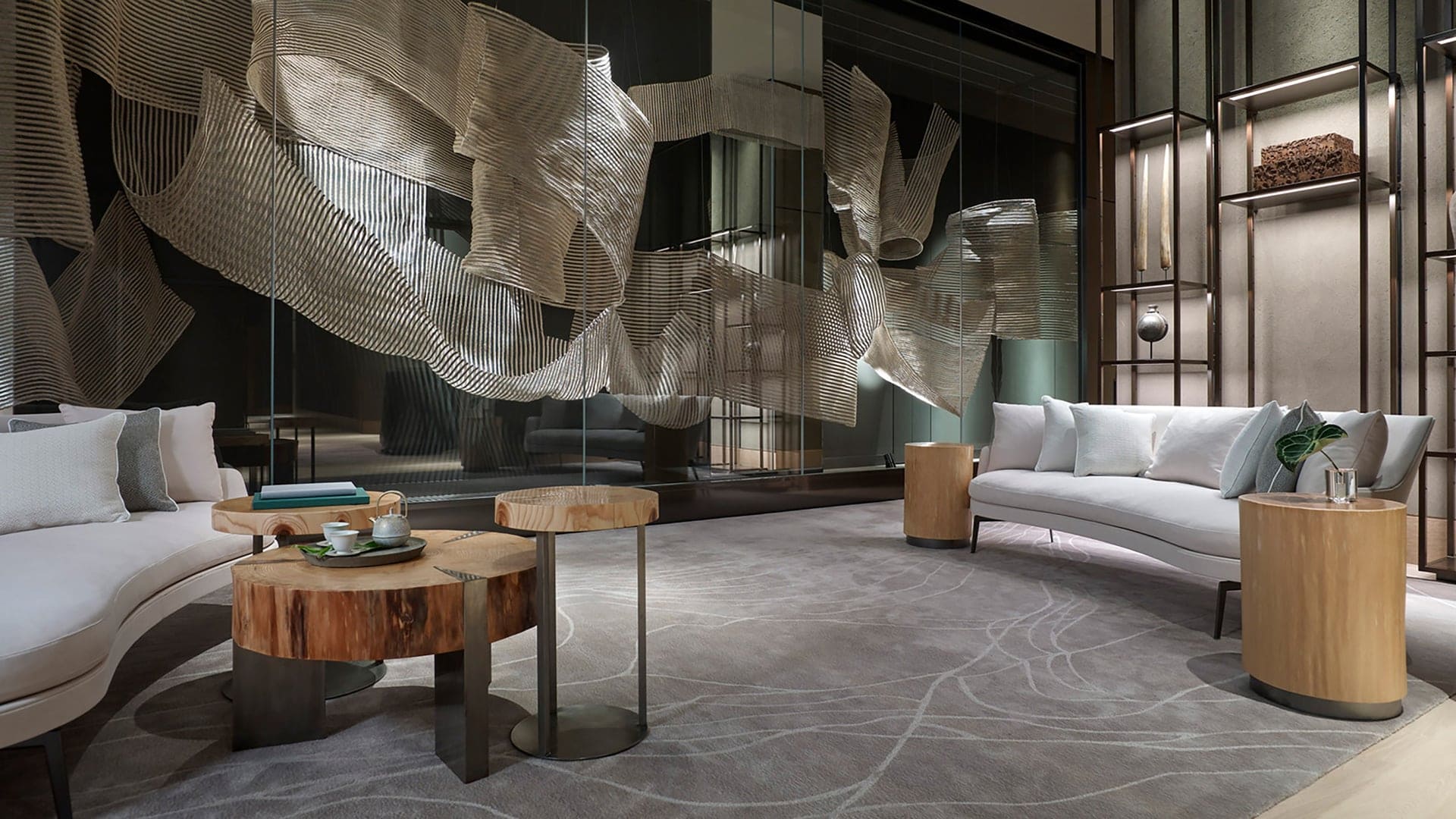 Lounge area with large floor to ceiling space, grey sofas, wood furniture, and futuristic design