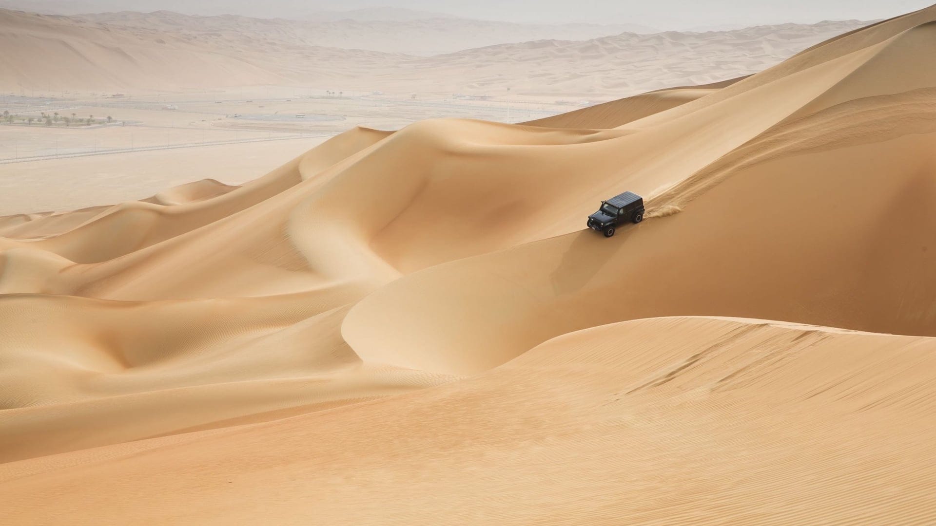 car riding in the desert in abu dhabi