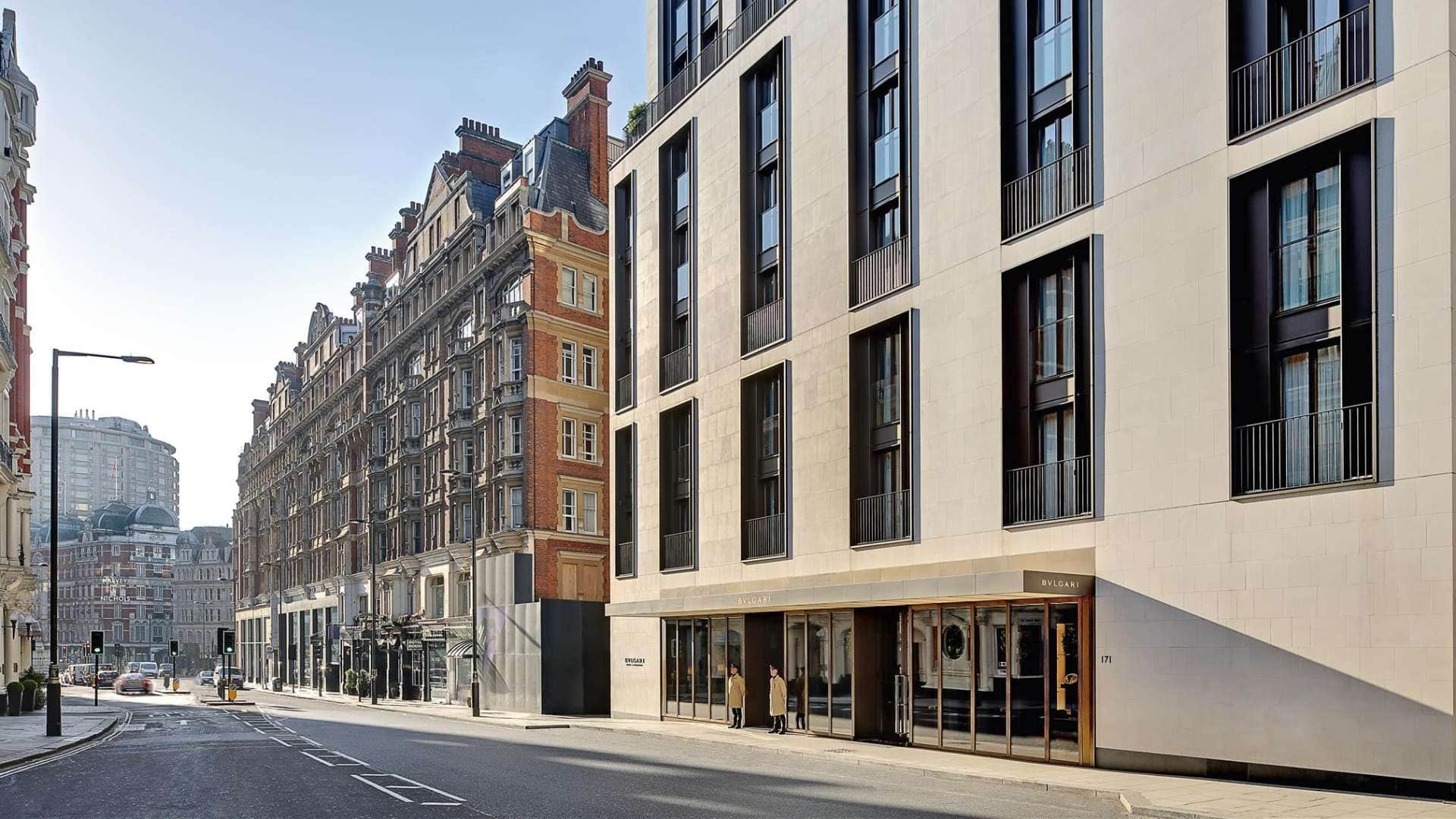 Front entrance of bulgari hotel london with two doormen standing infront.
