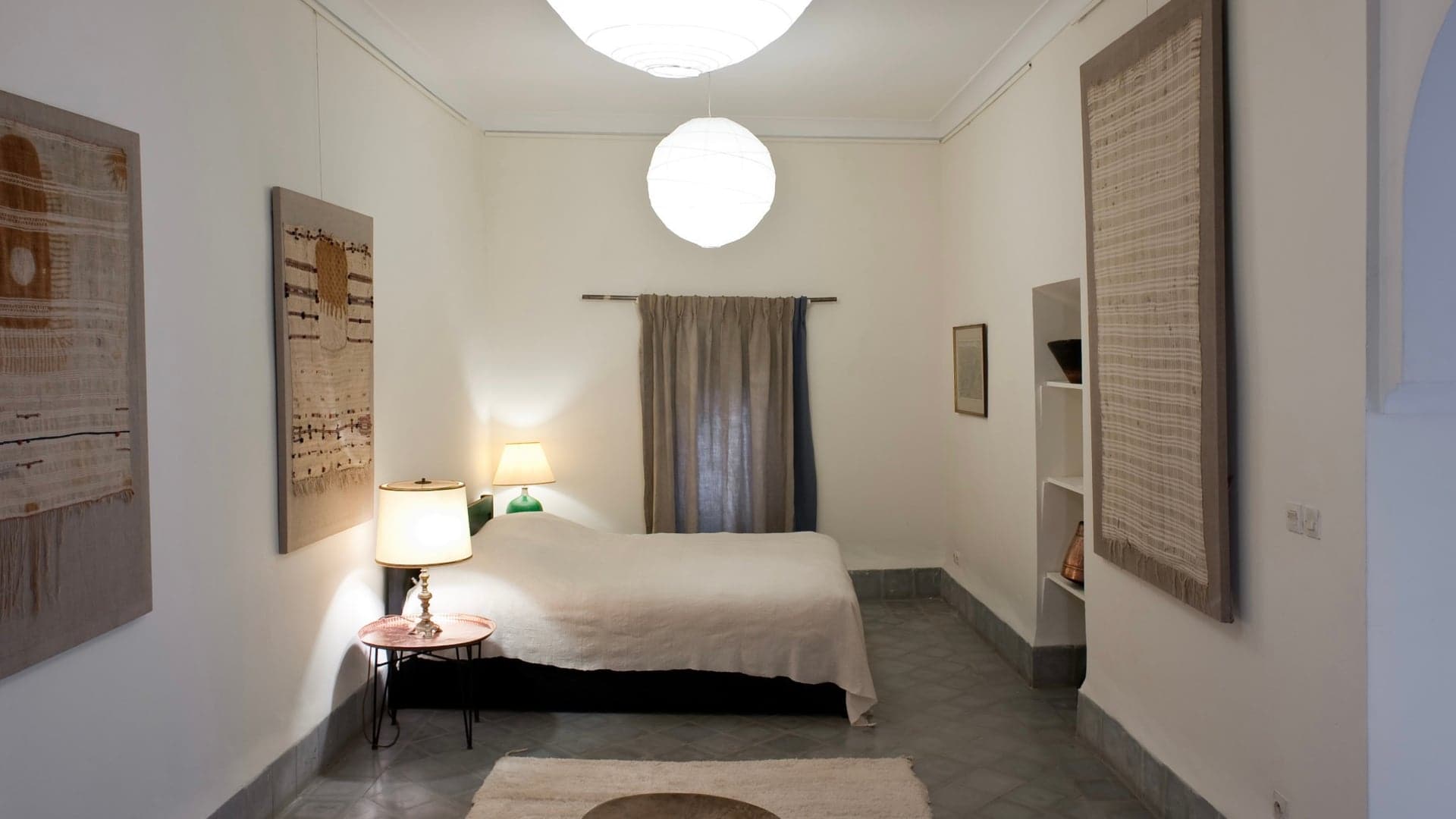 Bedroom with white decor, art on the wall inspired by Morrocan style