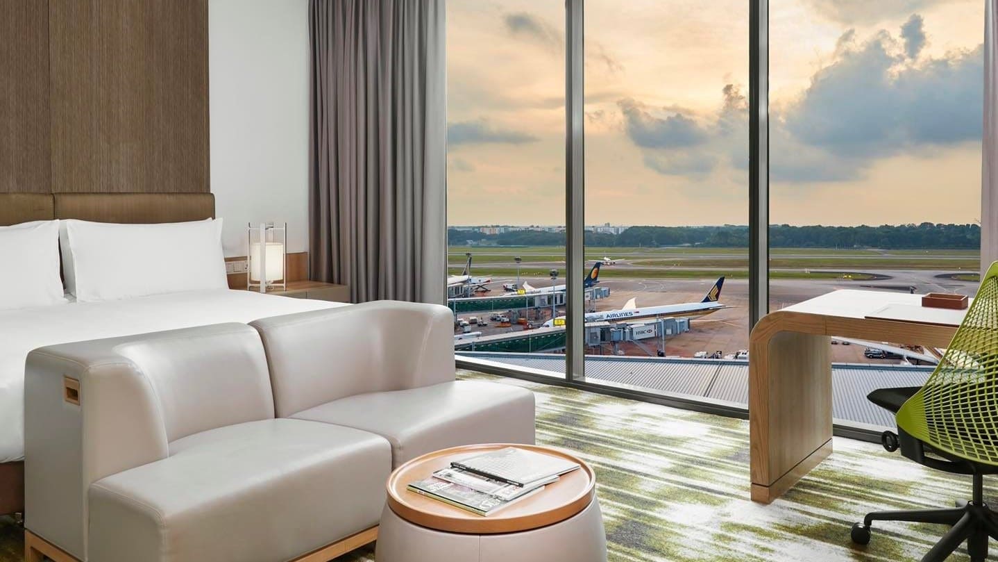 White couches, large windows at Crowne Plaza