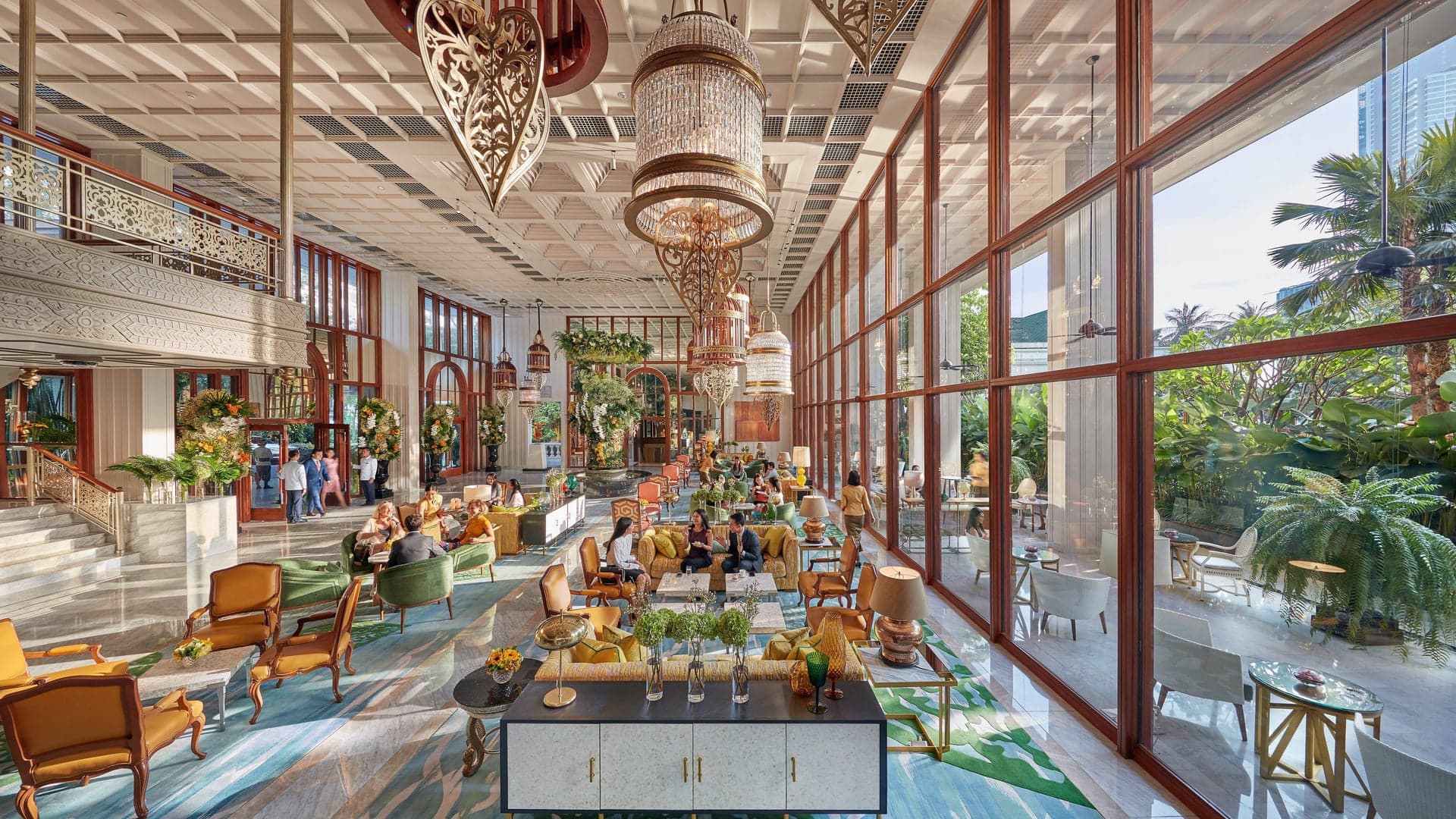 Tall doors with entrance to a large lounge featuring seating area, outside seating area, large under the roof and tropical and colourful design at Mandarin Oriental Bangkok, Thailand.