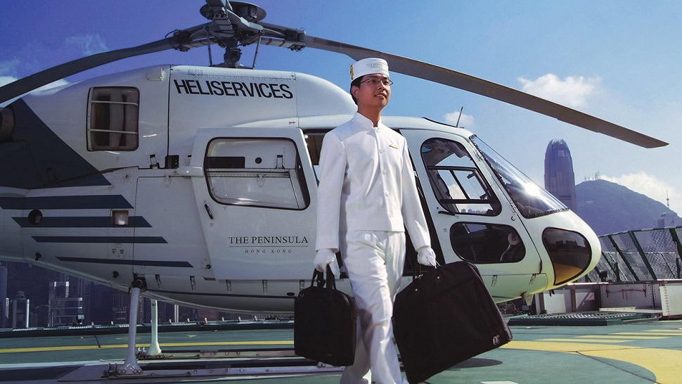 Employee at The Peninsuala Hong Kong holding luggage from James Bond