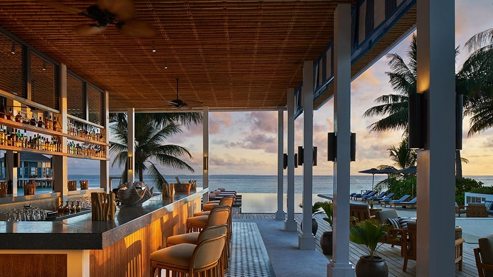 Bar and infinity pool at Raffles Maldives Meradhoo resort.