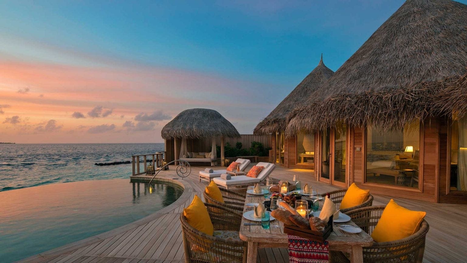 Dinner table, infinity pool with wooden floor and large suite at Nautilus.