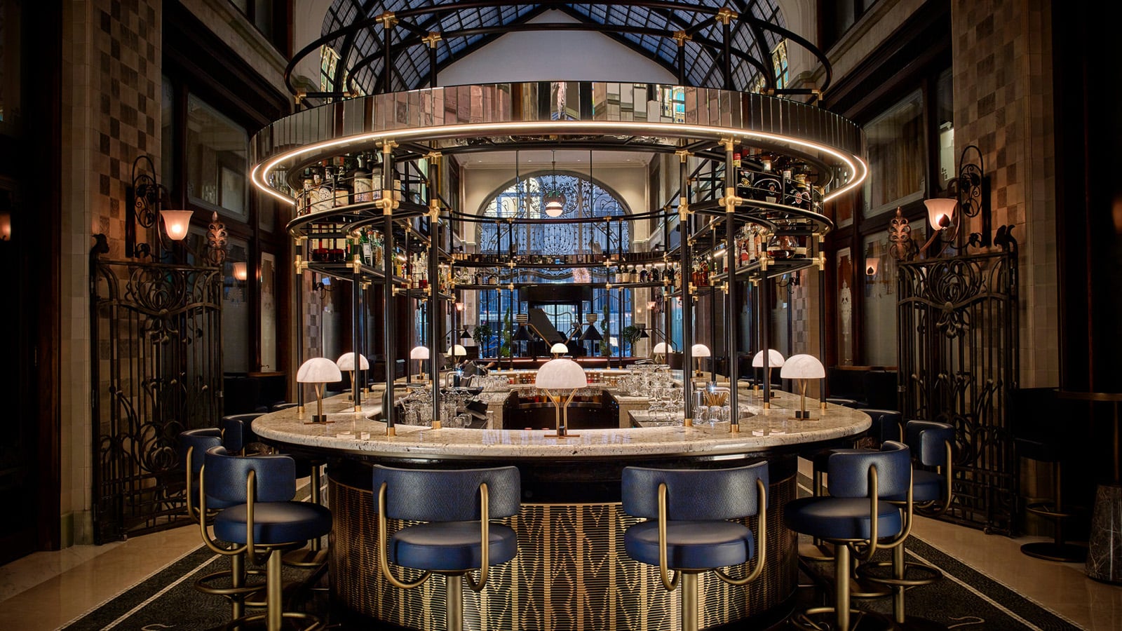 Bar area with marble decor and blue furniture at Four Seasons Hotel Gresham palace in Budapest.