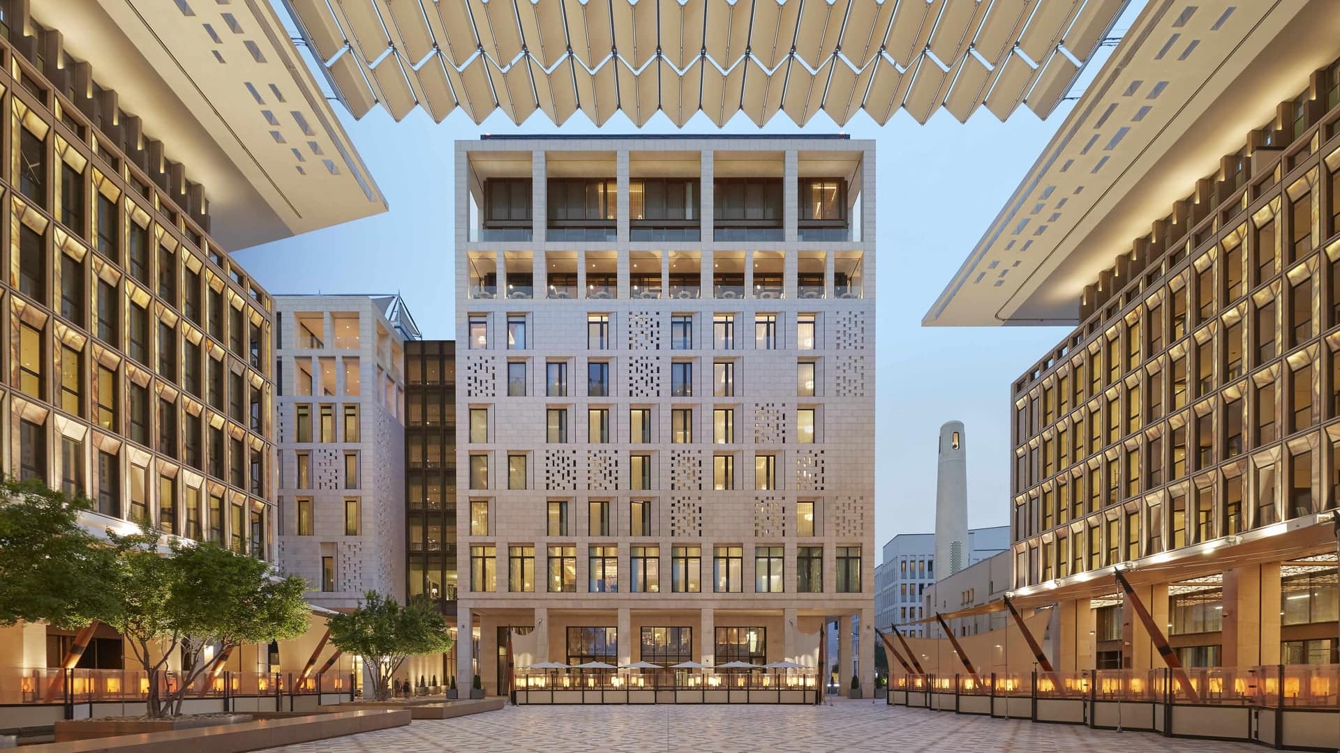 Outside view of The Mandarin Oriental Doha hotel, Large pathway in with a beautiful large buildning. 