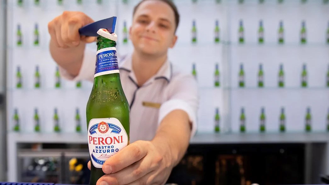 bartender opening a bottle of beer at Rex