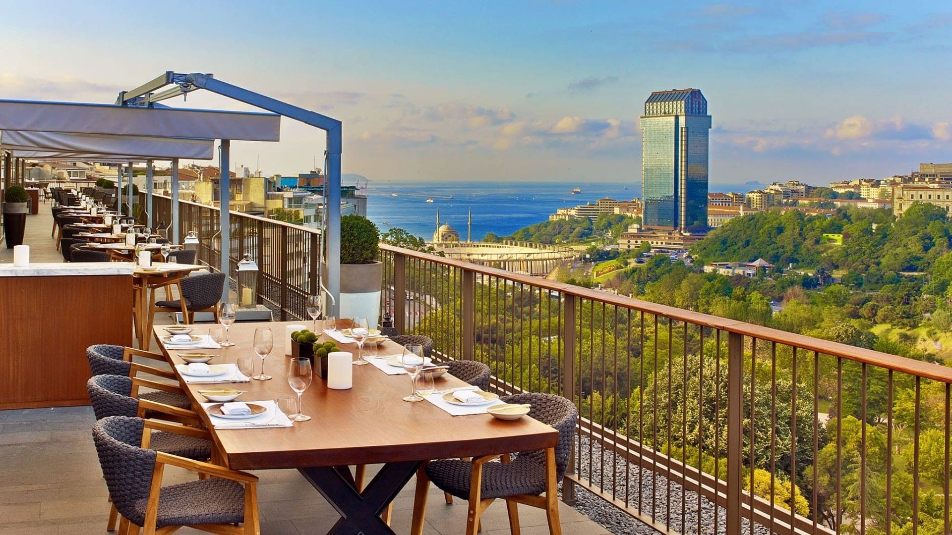 Outdoor dining at The Glamorous St. Regis Istanbul, offering a broad view of nature and city life