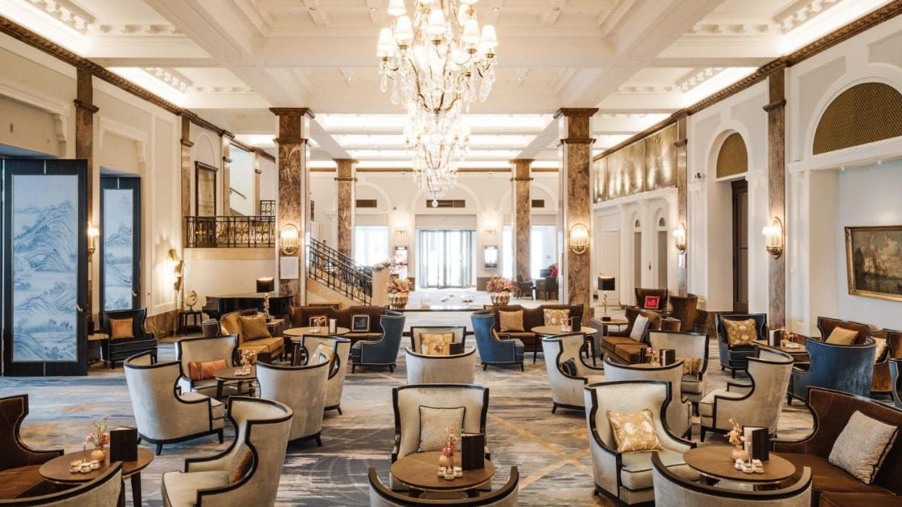 Lounge at Hotel Atlantic with seating, and white seating and marble design.