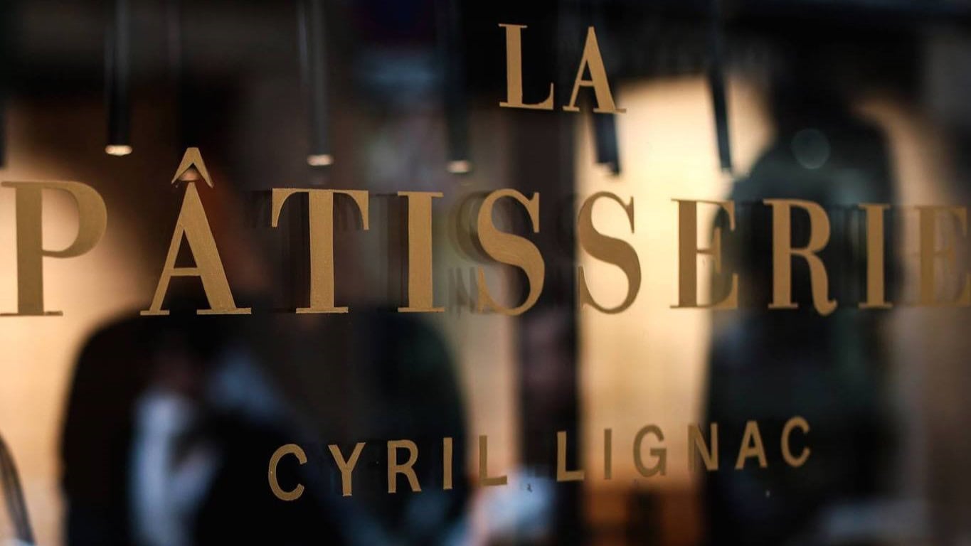 Glass window with text saying La Pâtisserie Cyril Lignac