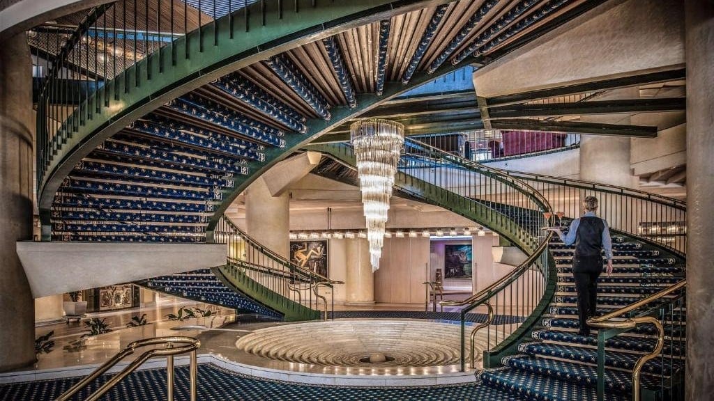 a waiter going up the stairs at Rome Cavalieri, A Waldorf Astoria Hotel's lobby