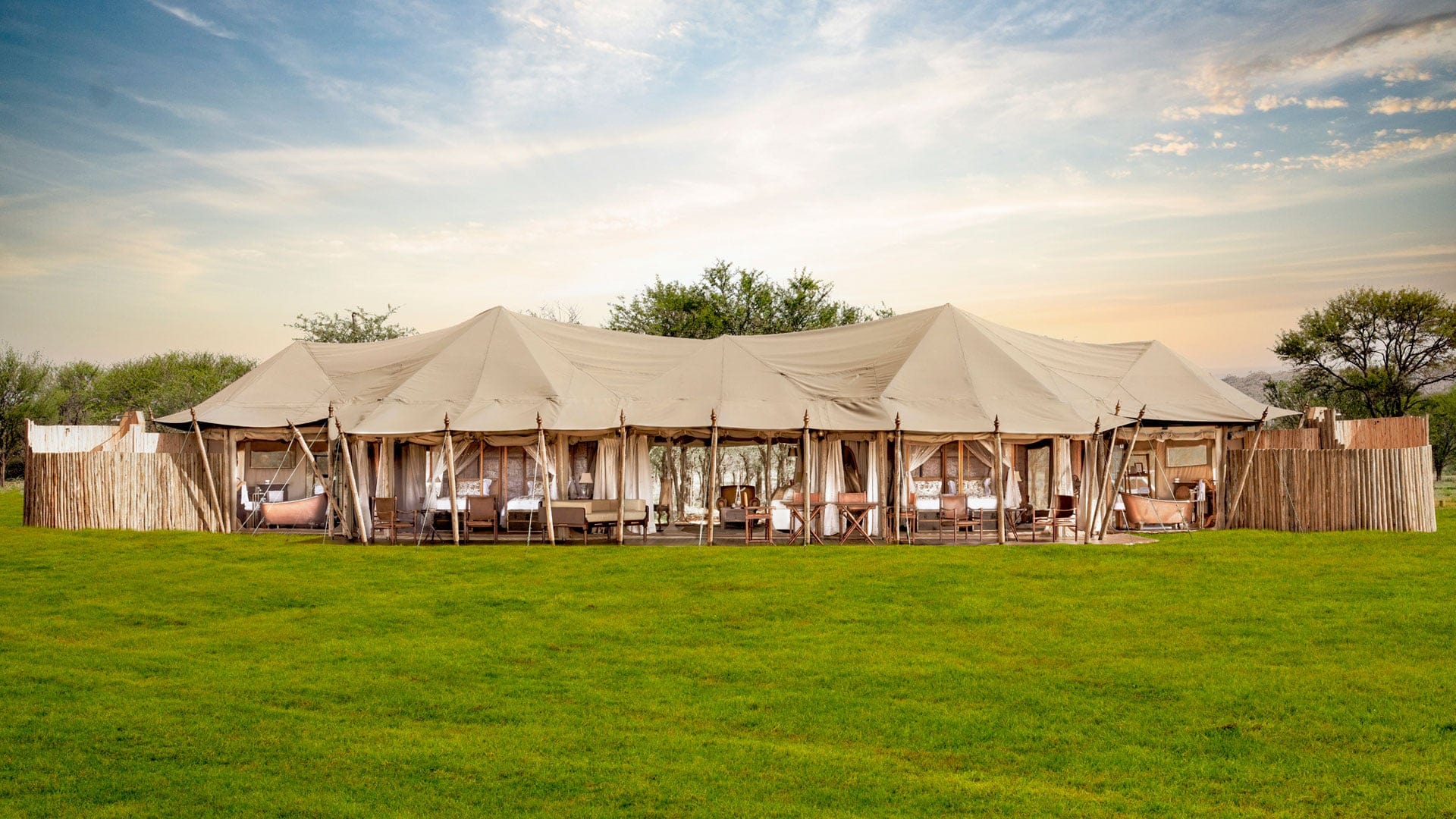 Cabin style suite with beige camoflage colour and beautiful trees and grass