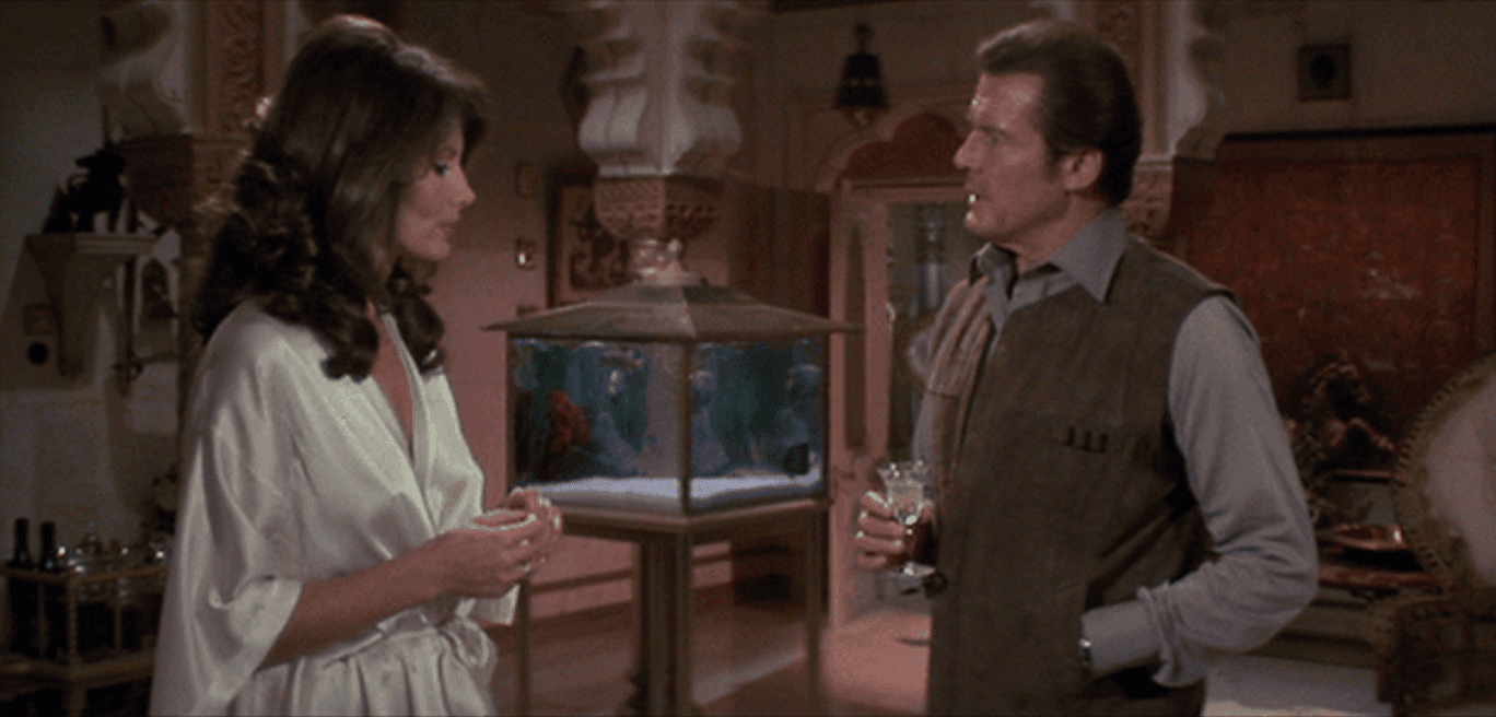 Roger Moore having a drink while talking to Maud Adams from the movie Octopussy 1983 in Taj Lake Place, Udaipur