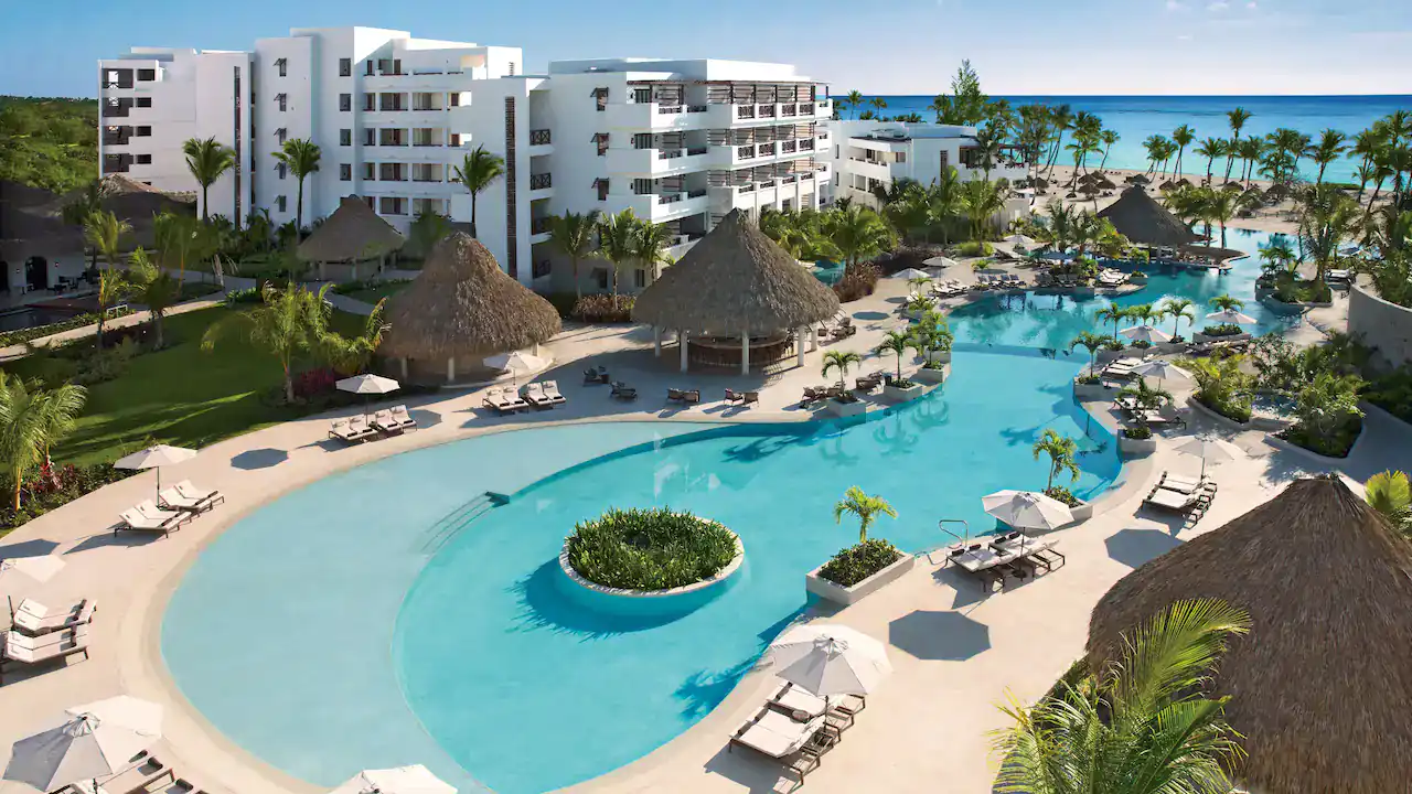 the swimming pool at the Secrets Cap Cana Resort & Spa with rooms behind it
