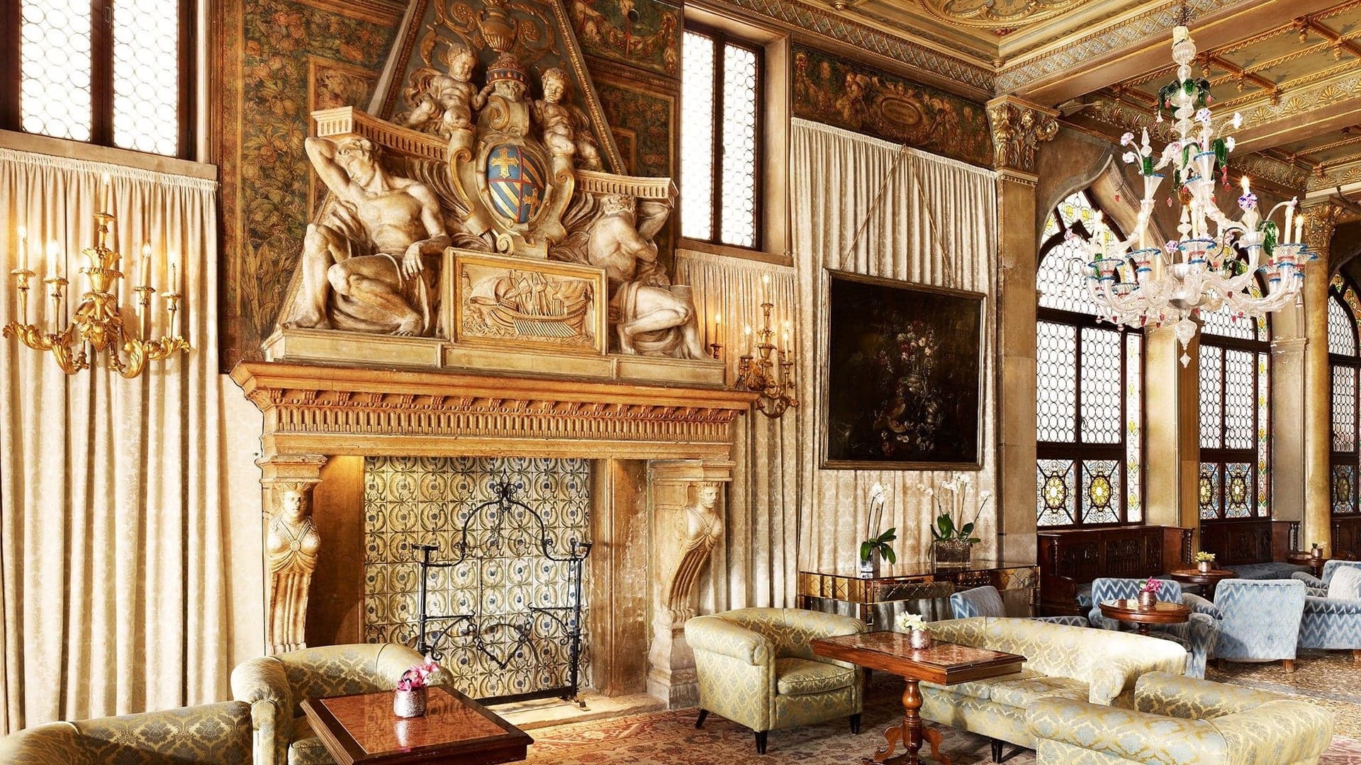 Lounge at Hotel Danieli with classical Italian design, paintings, sculptures, seating area and a golden design