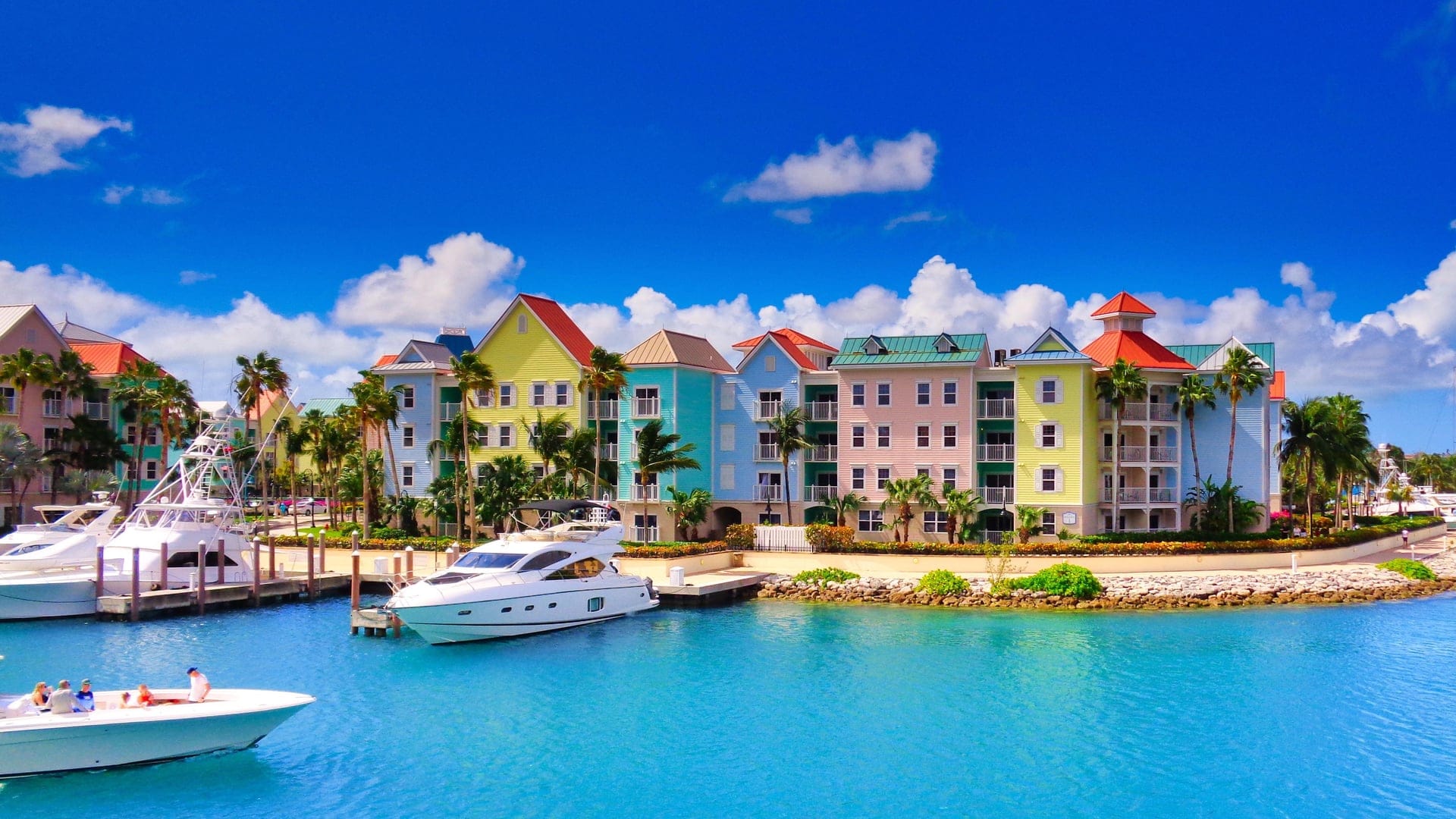 View of a colourful village and boats at Islands of Idyll, Bahamas
