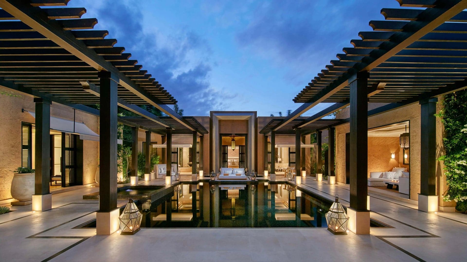 Swimming pool area with sunbed's and tender lighting at Mandarin Oriental Marrakesh