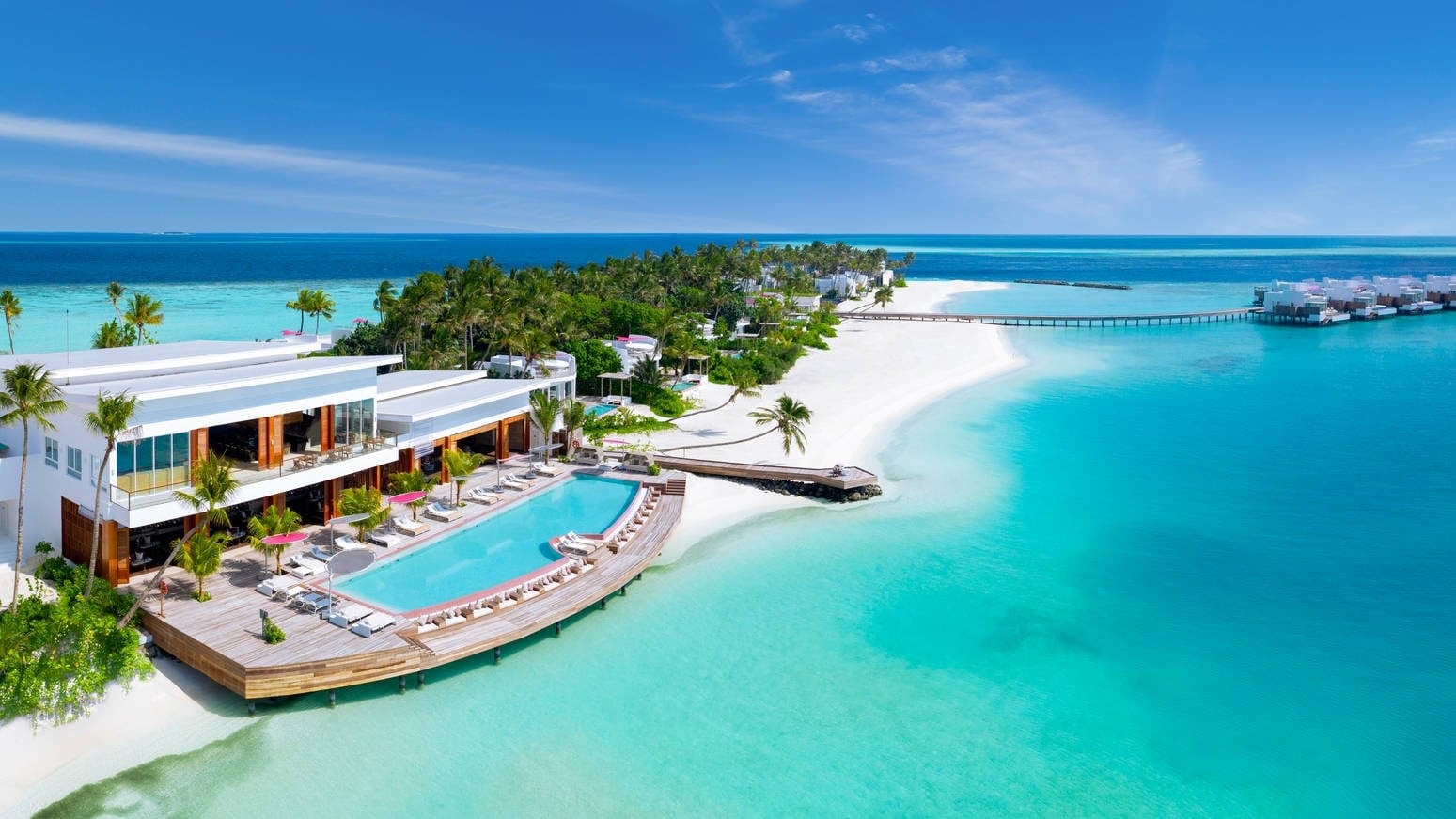 View of Jumeriah Maldives Olhahali Island with giant suite and palm trees.