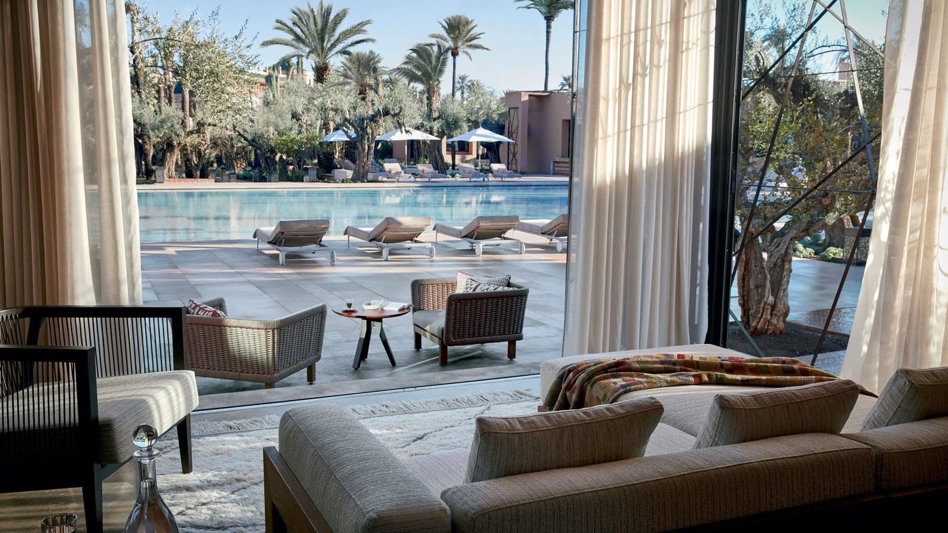 Private swimming pool with sunbed's and chairs inspired by Moroccan style at Royal Mansour Marrakesh