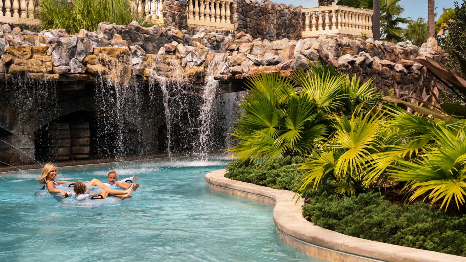 woman and two kids in a pool at four seasons resort orlando