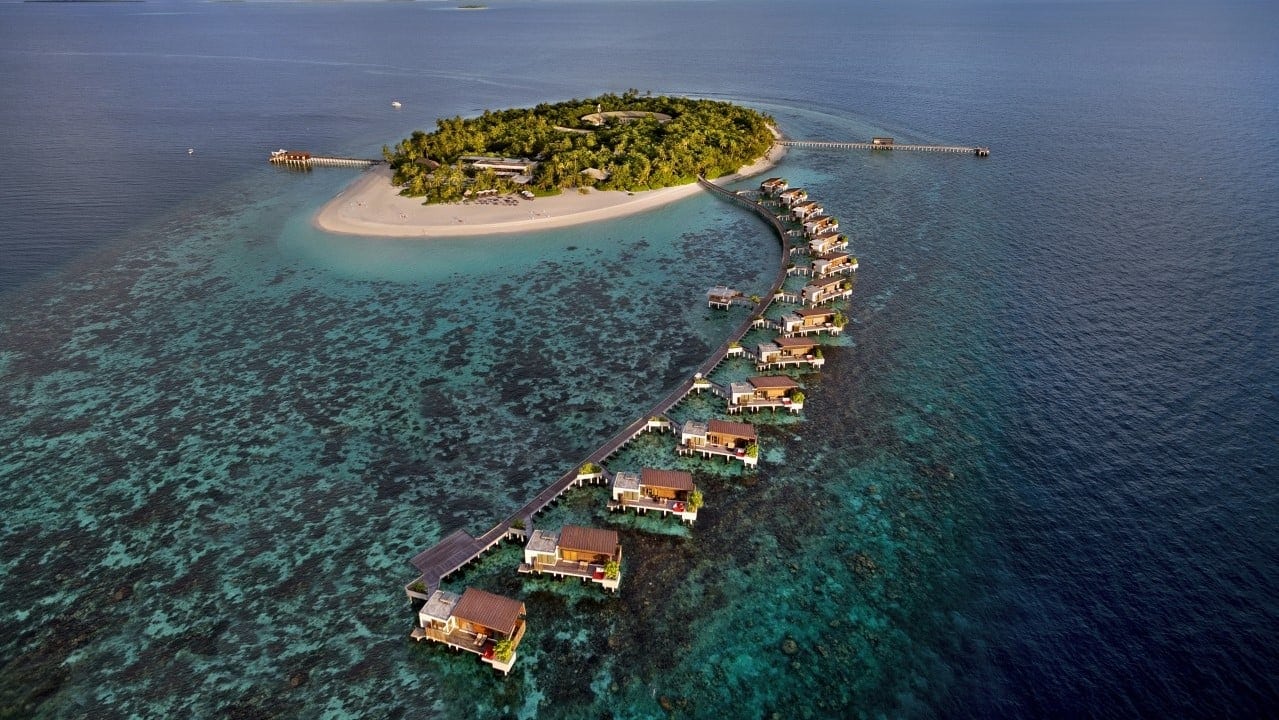 Bird view of Park Hyatt Maldives Hadahaa with cabins, sand, and forests.