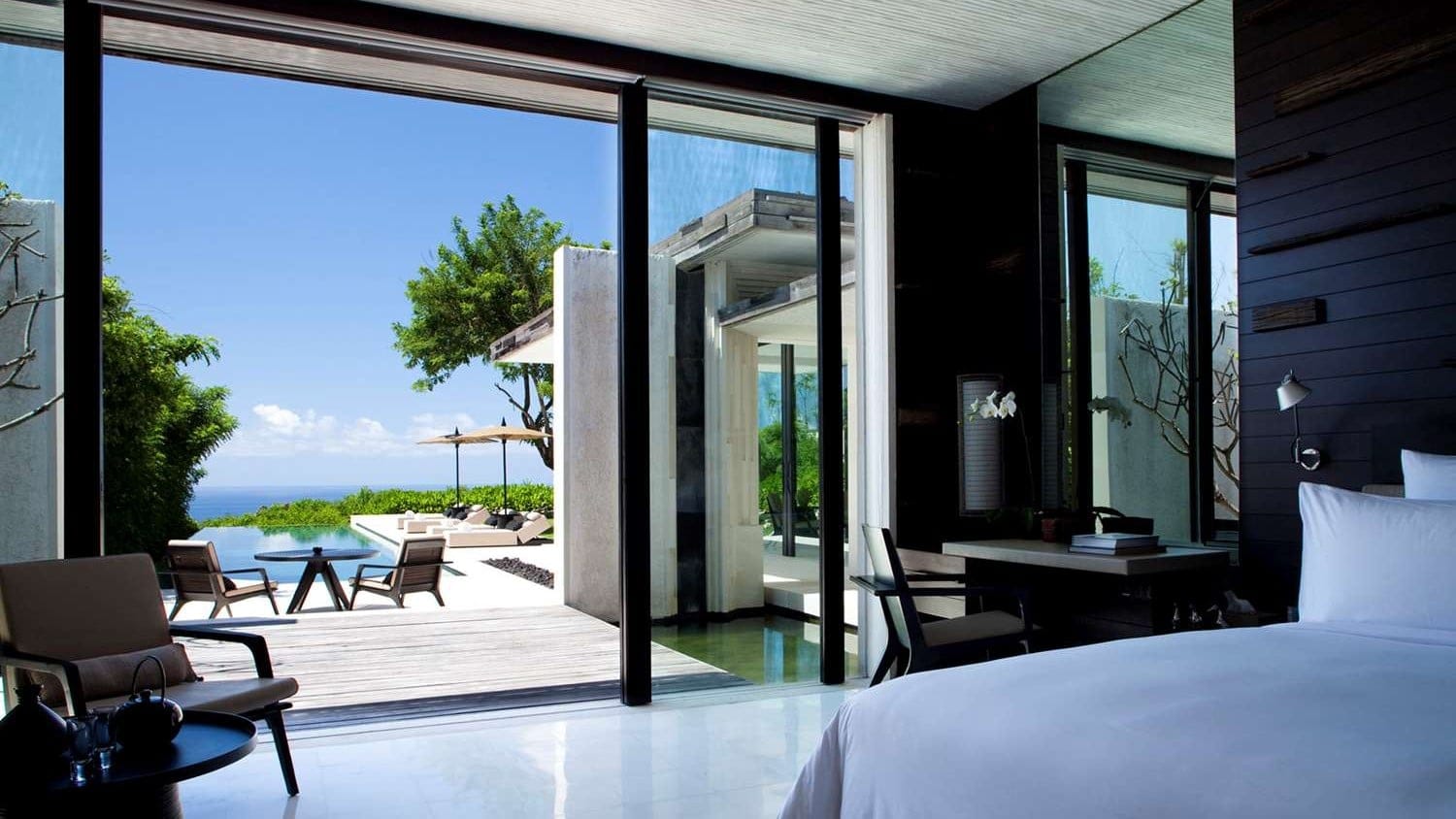 a room at the Alila Villas Uluwatu with a balcony and swimming pool