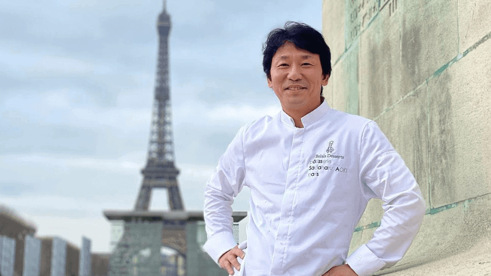 Chef from Sadaharu Aoki, Paris standing in his uniform with the Eiffel Tower behind him