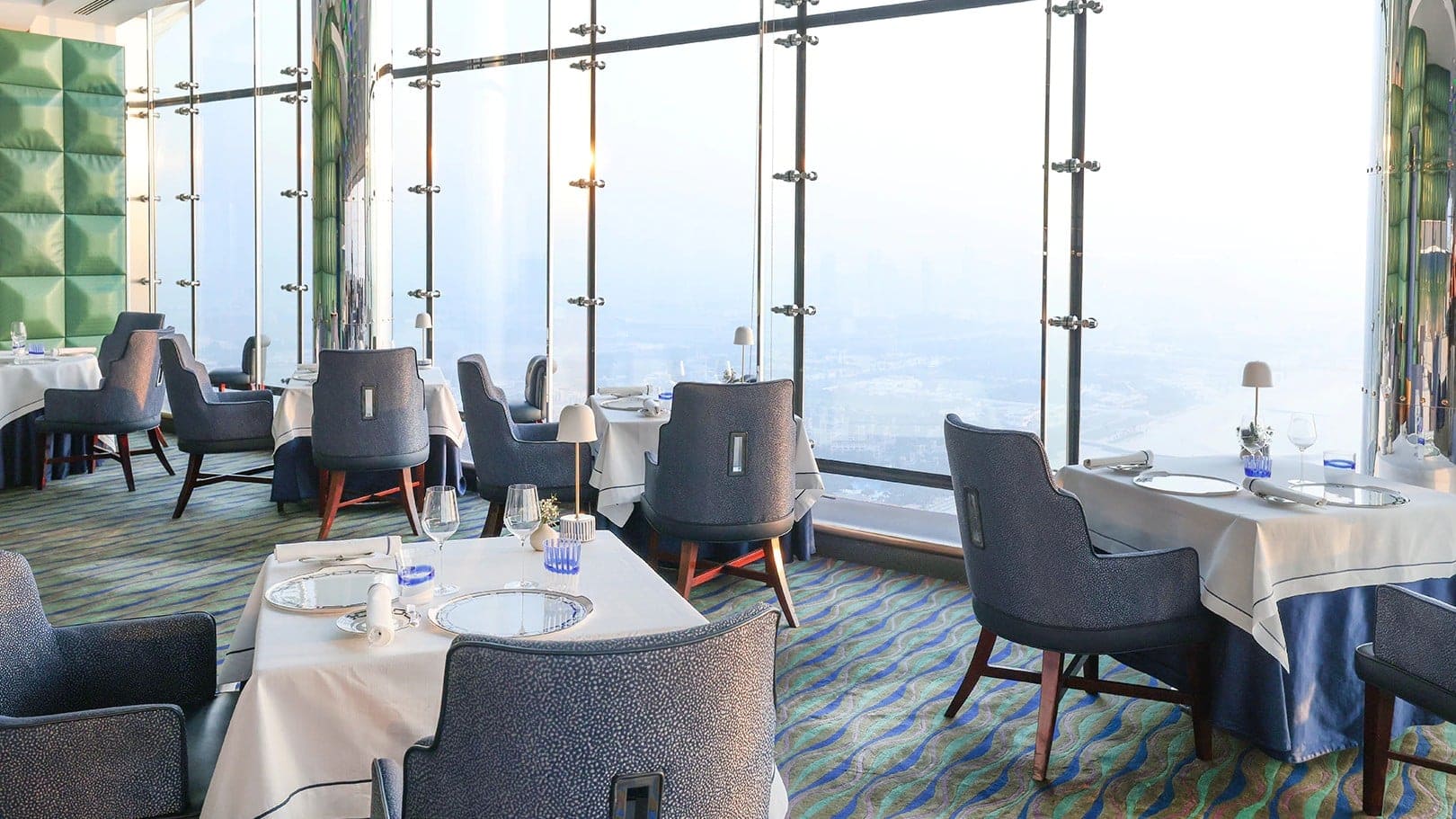 Al muntaha resturant in dubai with blue chairs and big glass windows