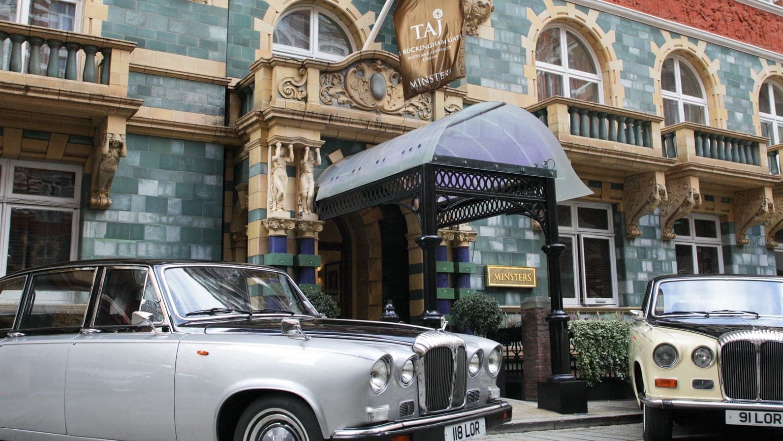 Front entrance of Taj 51 Buckingham Gate Suites and Residences London with two cars infront