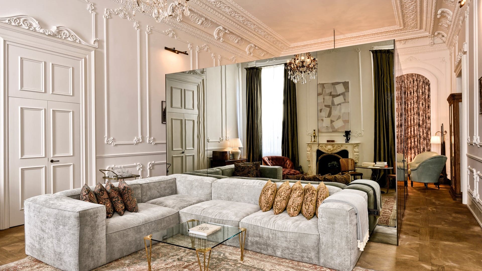 Deluxe-room at the The Trendy Soho House offering a modern feel with grey couches, grand mirror and large space