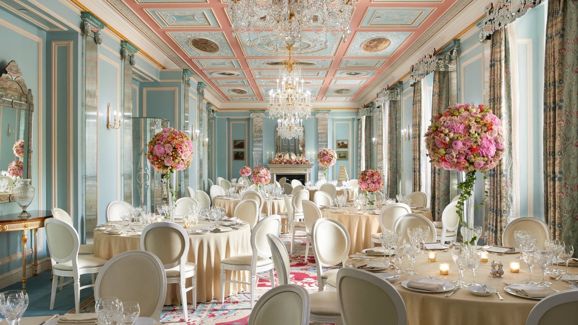 Resturant with blue walls and tables decorated with flowers at the lanesborough, london.