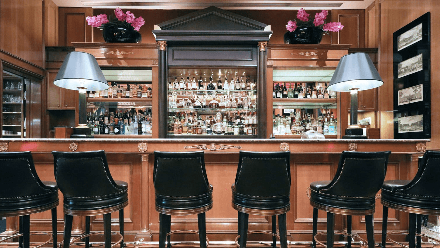 Le Bar inside Four Seasons Hotel George V with black chairs and cocktail closet.