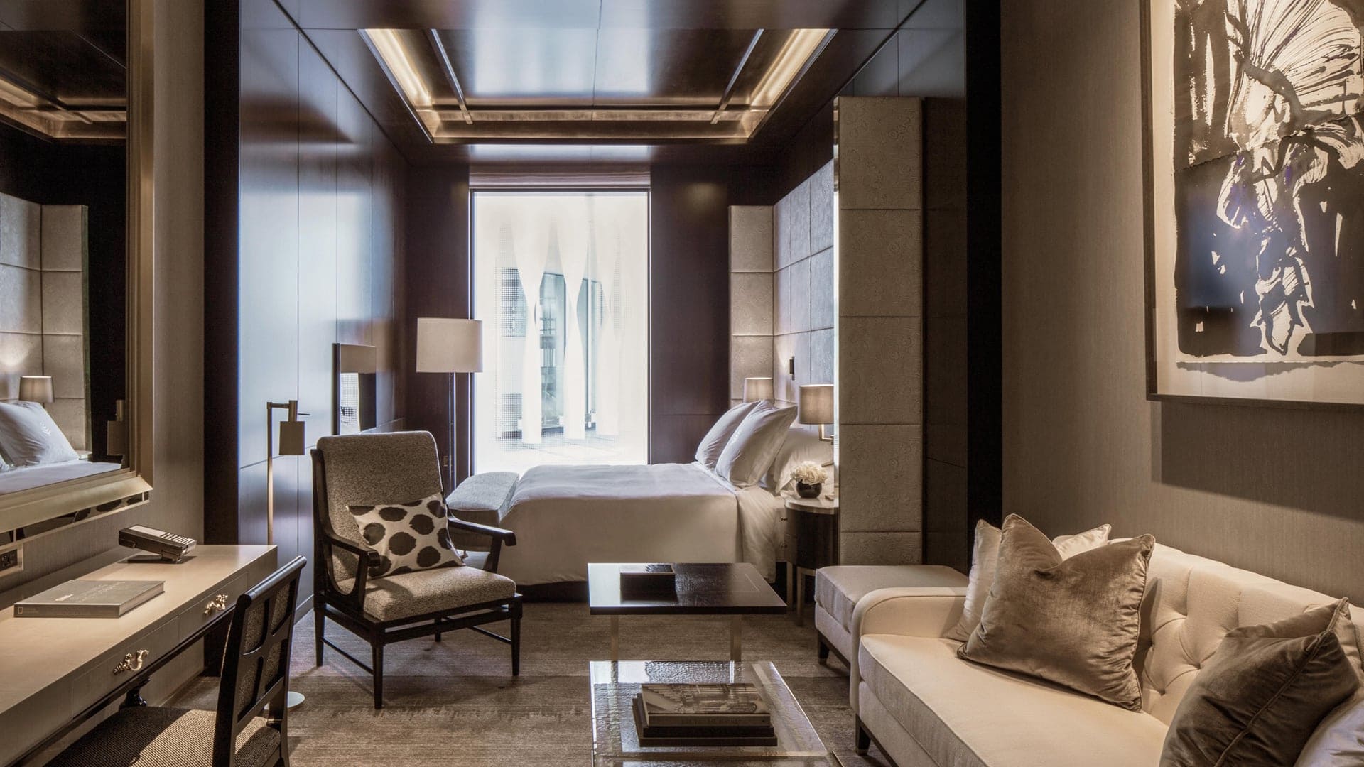 Grey, futuristic design with no colour blasts but matching grey decor, seating area and window.