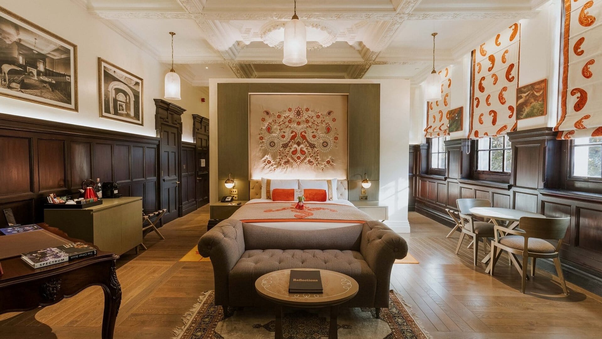 A large suite with a king sized bed high under the ceiling at the lalit london