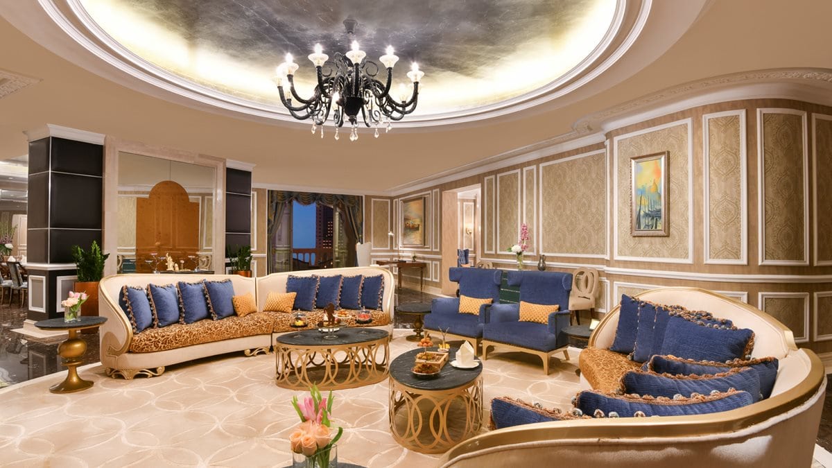 Photo of a hotel room inside Marsa Mlaz Kempinski, The Pearl - Doha with a large lounge with sitting area and chic design.