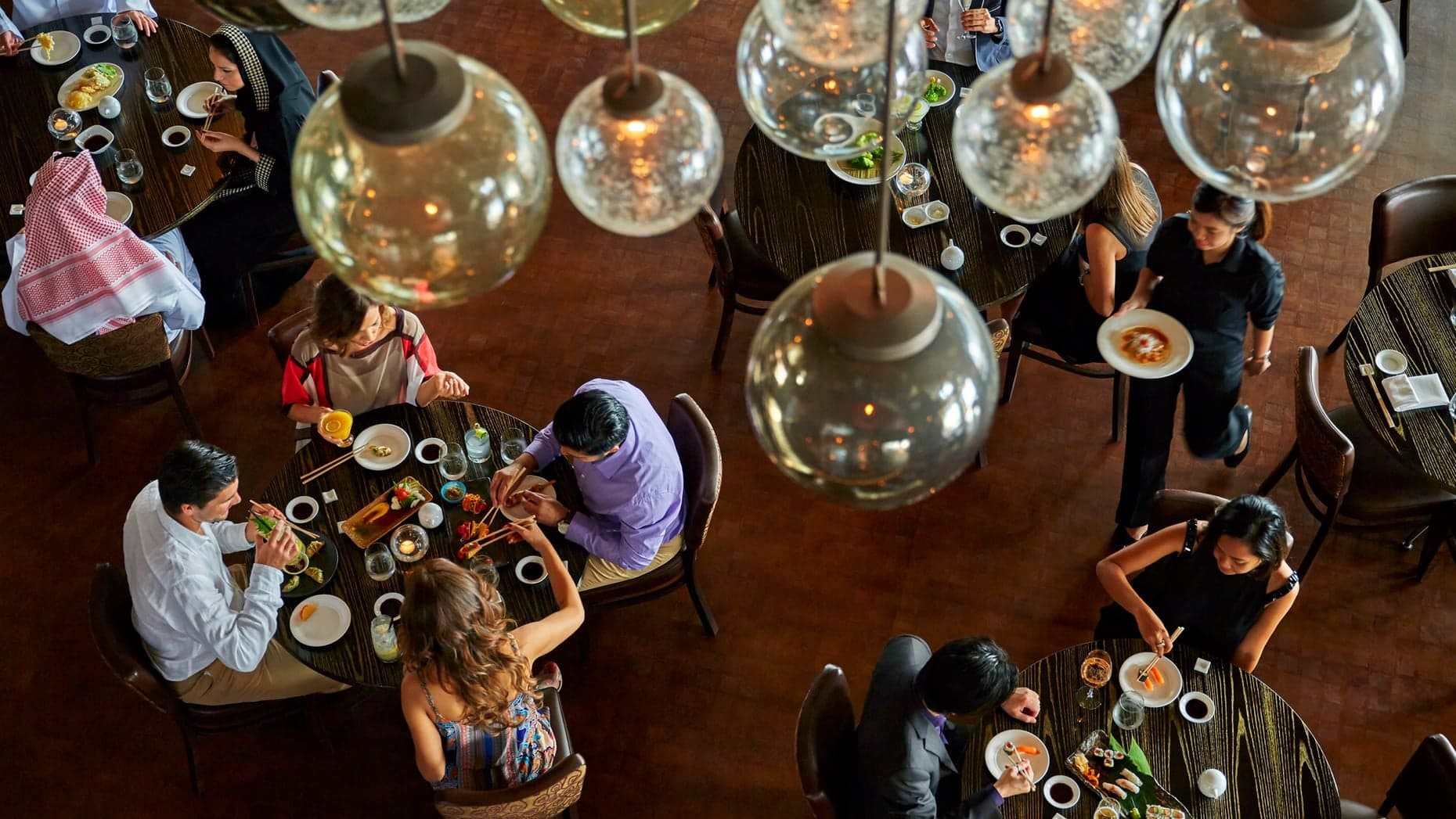Four Seasons Hotel Doha, indoor dining area with a modern tree look and beutiful lamps.