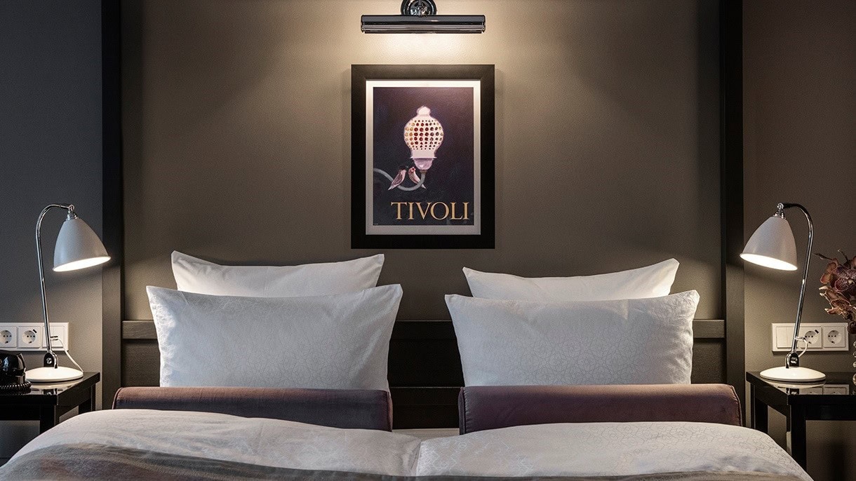 suite with a king sized bed at nimb hotel copenhagen