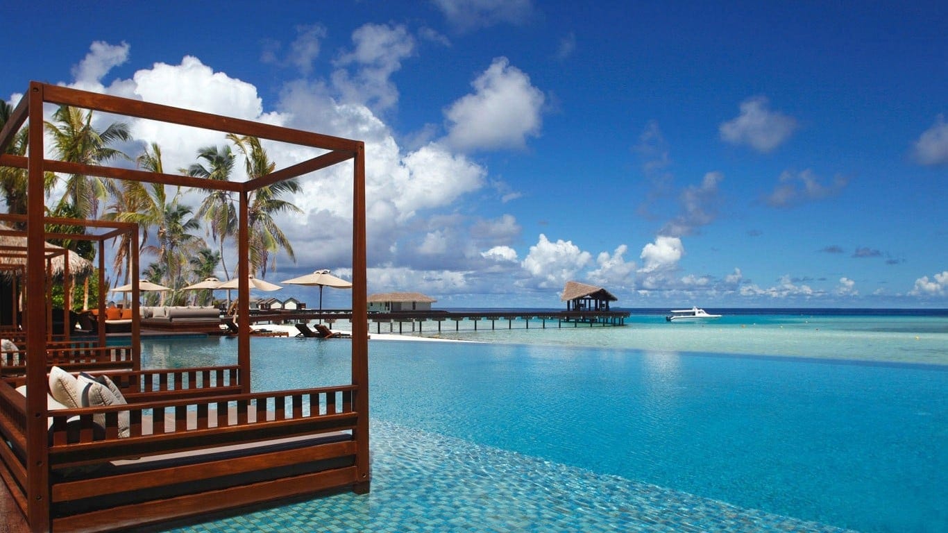 Floating sunbeds in infinity pool at The Residence Maldives.