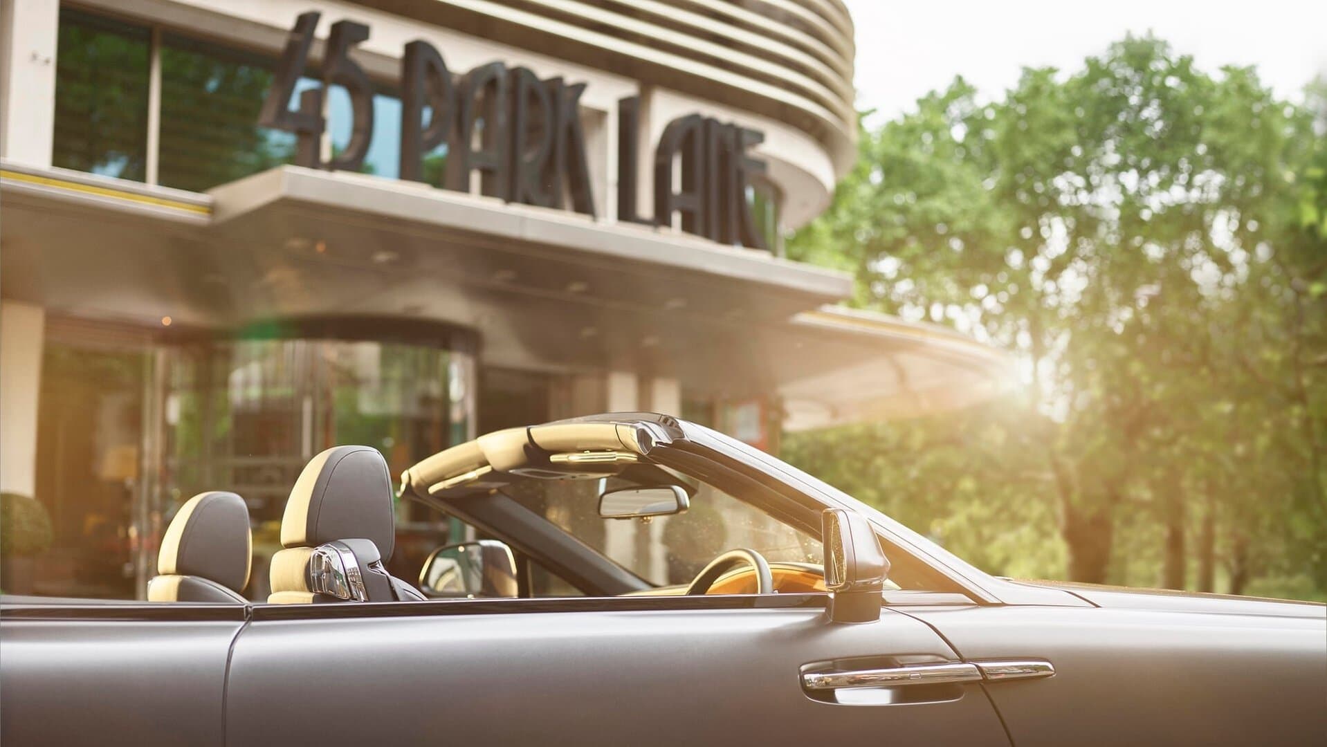 Front entrance of 456 park lane with a car in the foreground and the hotel in the background.