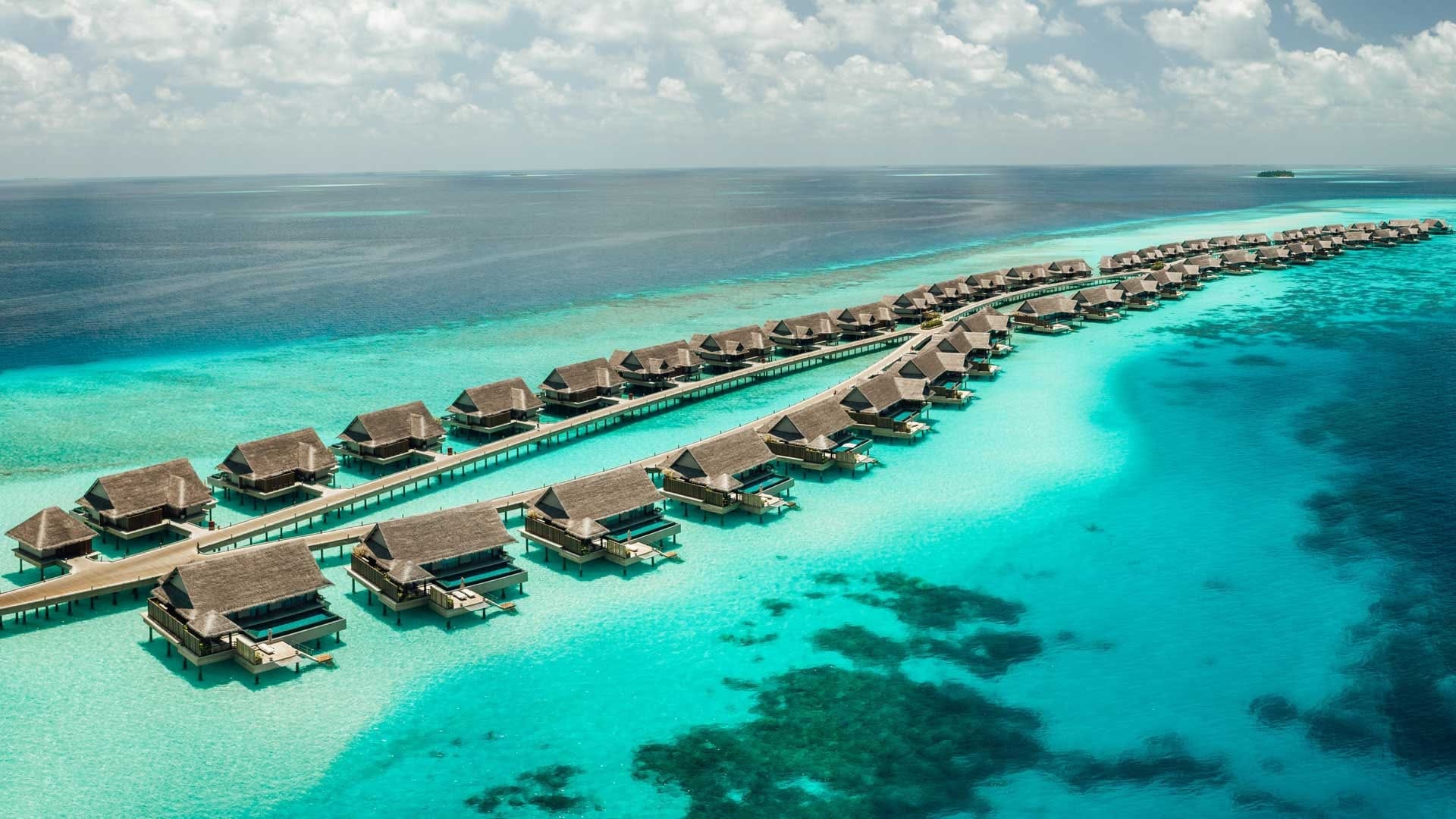 JOALI Maldives, clear water and a lot of water suites in wooden.