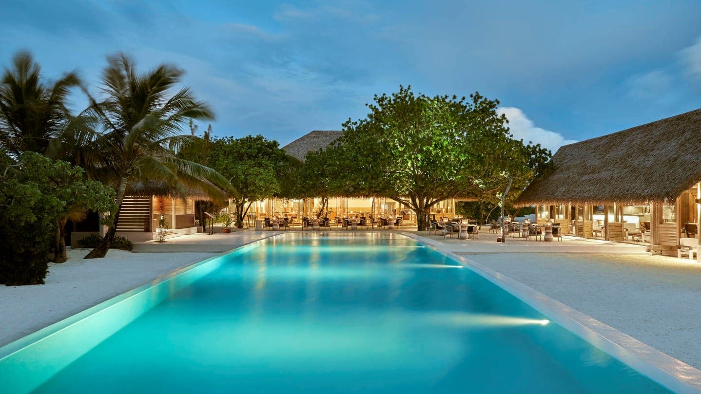 Giant pool with large dining club at COMO Cocoa Island.