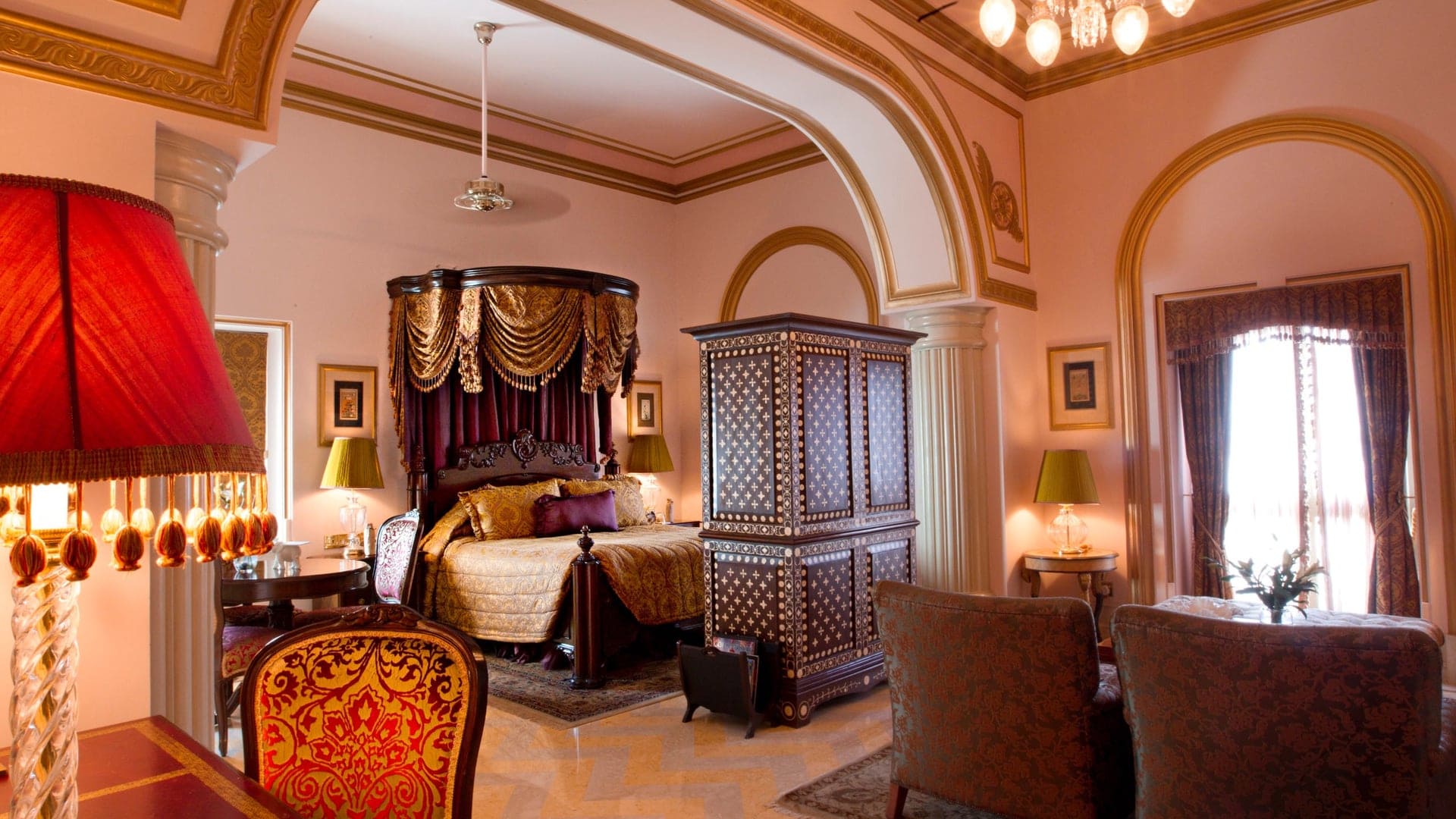 Suite at Taj Lake Palace inspired by Indian Royalty with lattice ceilings, indian silk and dark teak furniture.