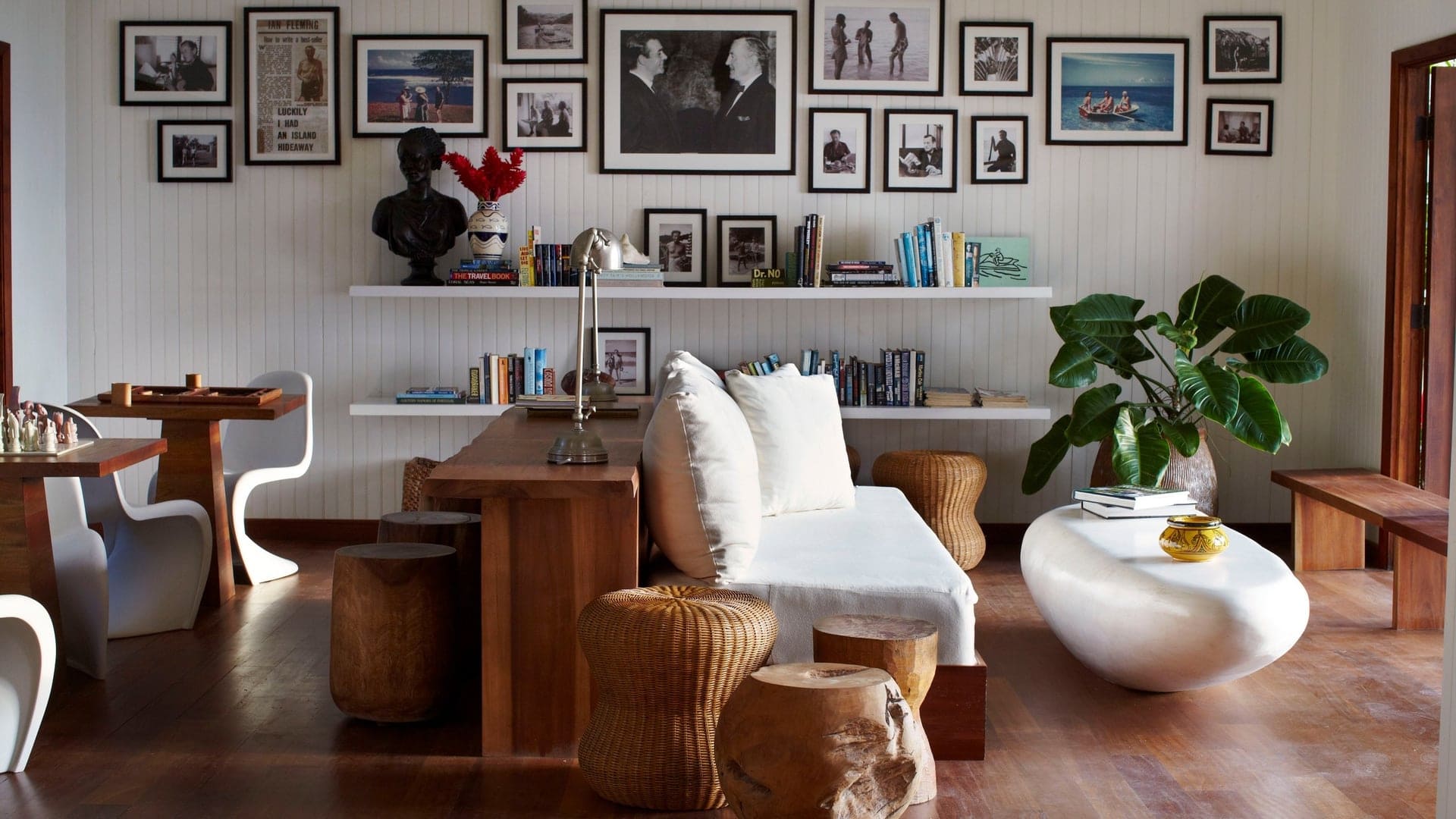 Beach design with oak brown and white decor, books, and open door to outside.