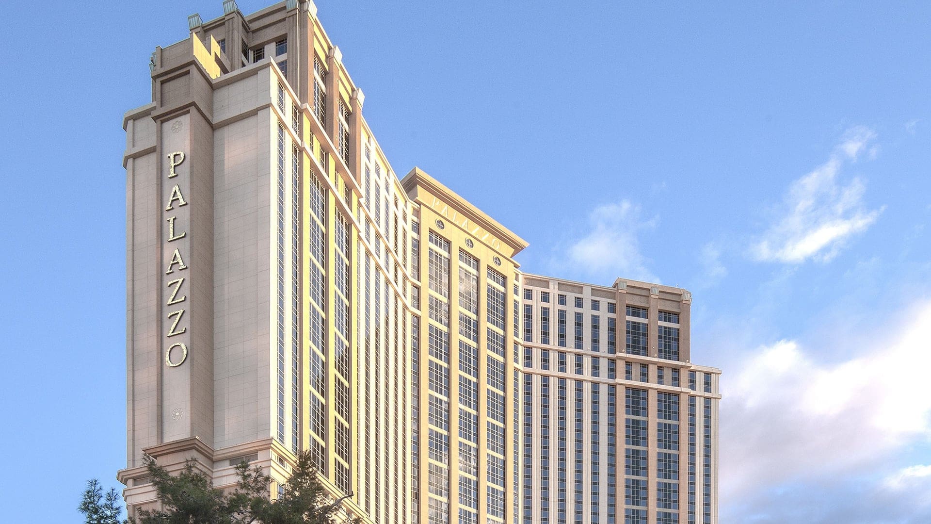 View of The Palazzo at The Venetian Resort with a inward facing structure, hundreds of windows and in the middle and side text saying: PALAZZO.