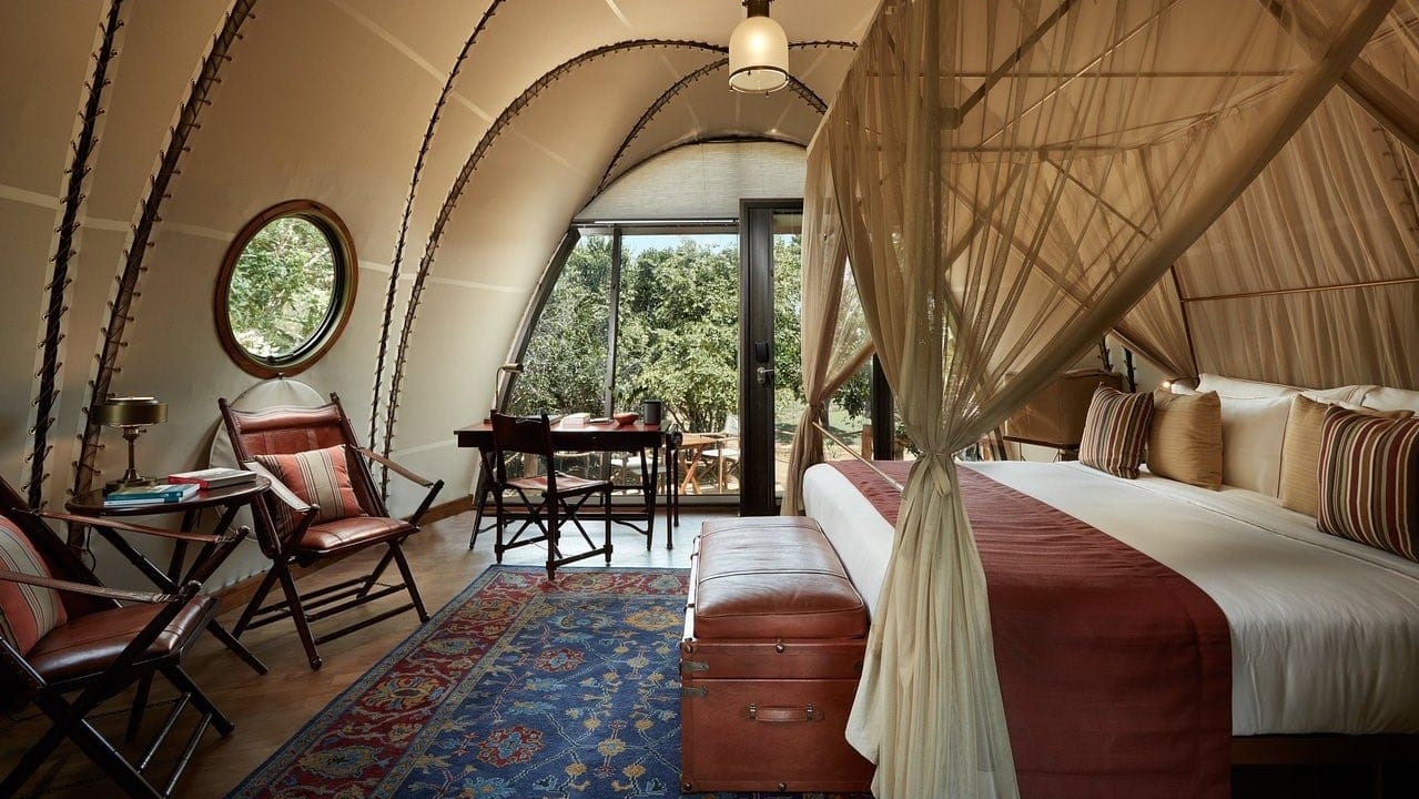 Suite at Wild coast Tented Lodge with kingsize bed, chairs and windows to nature